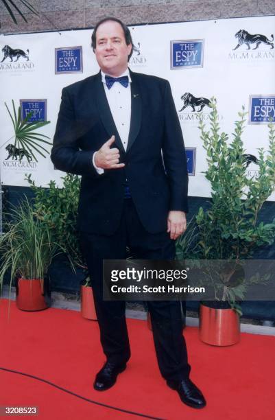 Full-length image of ESPN football commentator Chris Berman making a hand sign while standing on the red carpet at the eighth annual ESPY Awards, MGM...