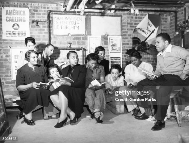 Instructor Elmer House listens to an oral recitation by members of his first aid class, in an air warden unit in the southwest area, Washington, D.C.