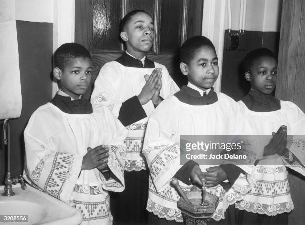 Four African-American altar boys stand in St. Elizabeth's Roman Catholic church on the south side of Chicago, Illinois.
