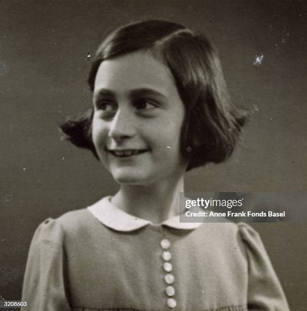 Passport photo of Anne Frank looking to her right, taken from her photo album, Amsterdam, Holland.