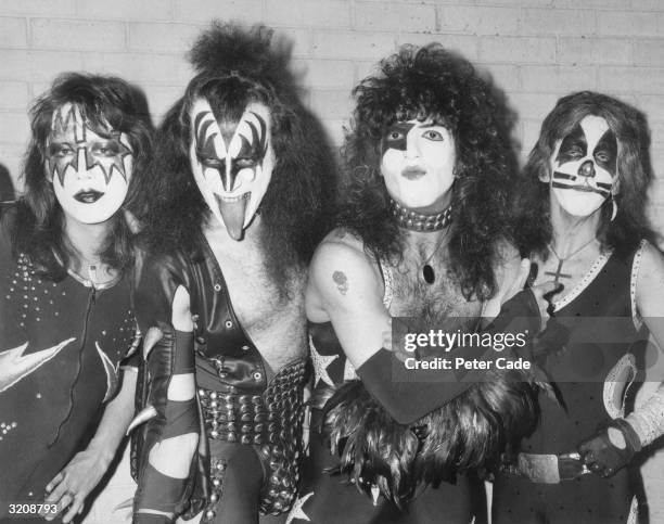 American rock group Kiss arrive at London airport for their first European tour, already sporting black and silver make up and costumes. From left to...