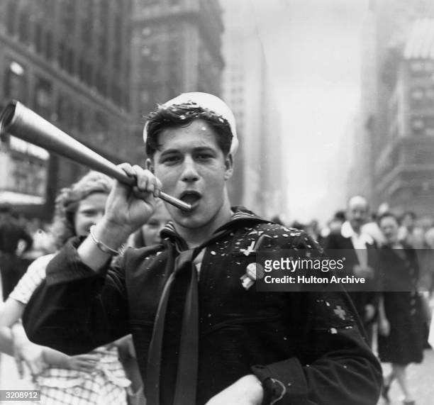 Sailor blows a horn during the VJ Day celebrations in Times Square, New York.
