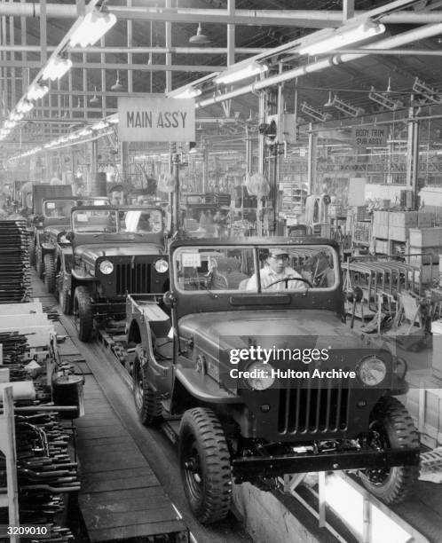 Interior view of the main assembly line where Willys Jeeps are manufactured at a Mitsubishi factory, Japan.