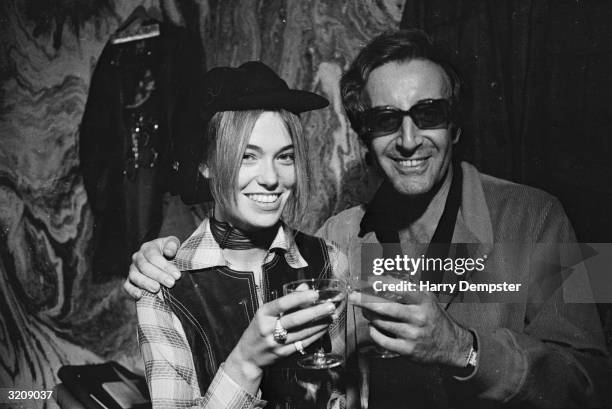 British actor and comedian Peter Sellers and his wife, Miranda Quarry, make a champagne toast after their wedding ceremony at Caxton Hall.