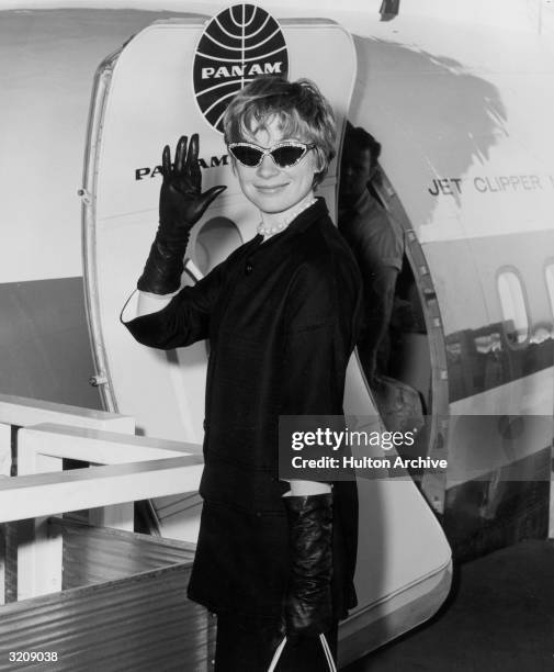 American actor Shirley MacLaine waves as she boards an airplane bound for Italy to attend the Venice Film Festival, where director Billy Wilder's...