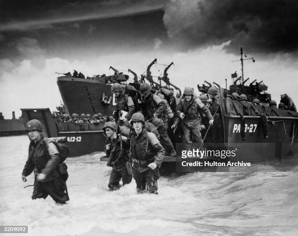 Reinforcements disembarking from a landing barge at Normandy during the Allied Invasion of France on D-Day.