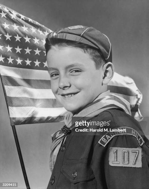 Studio portrait of a Cub Scout from Troop 107, Barren Hill, posing in front of a US flag.