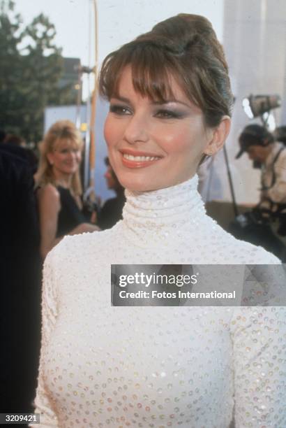 Headshot of singer Shania Twain at The Grammy Awards, Los Angeles, California. Twain wears a white turtleneck covered in rhinestones.