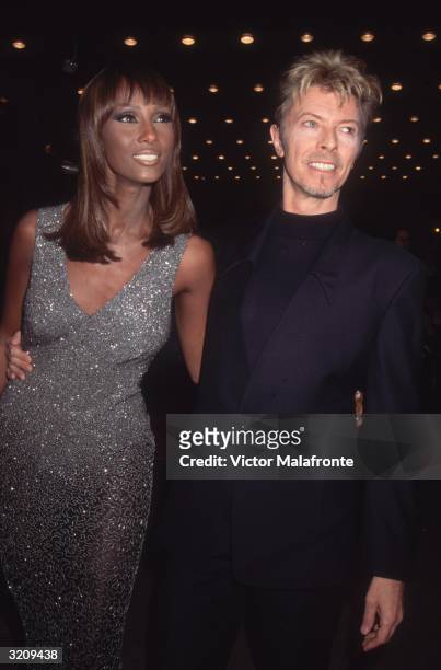 Somalian-born fashion model Iman and her husband, English singer and actor David Bowie, attending the 6th annual Shakespeare Gala. Iman wears a...