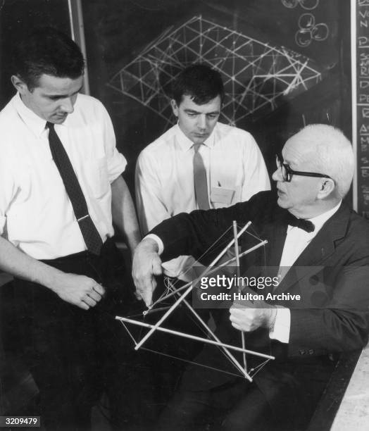 American architect and engineer Richard Buckminster Fuller demonstrates his model for low cost housing for Asia at Long Beach State College,...