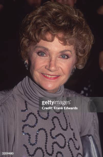 Headshot of American actor Estelle Getty wearing a gray turtleneck top with sequins.