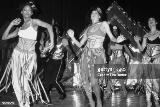 Full-length view of disco dancers performing in costume at the opening of Studio 54, New York City.