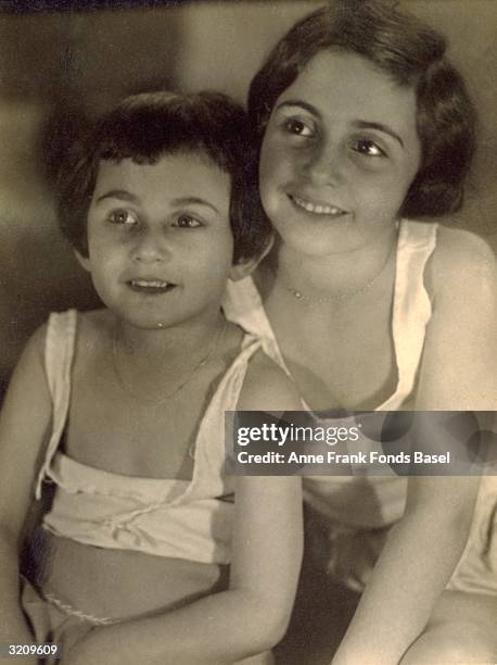 Anne Frank , and Margot Frank in undershirts in a portrait from the photo album of Margot, Frankfurt, Germany.