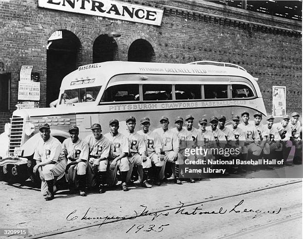 The 1935 Pittsburgh Crawfords of the Negro Leagues pose for a team photo in front of their team bus. The Crawfords are considered the greatest black...