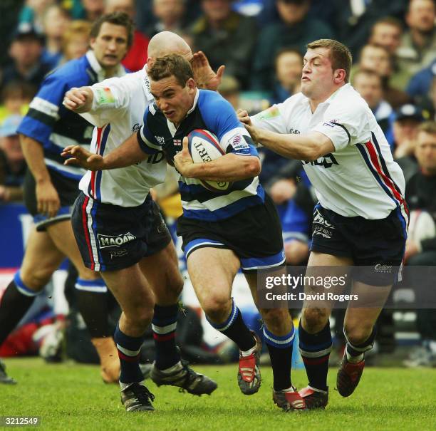 Olly Barkley of Bath is tackled by Mark Cueto of Sale during the Zurich Premiership match between Bath and Sale Sharks at Bath Rugby Ground on April...