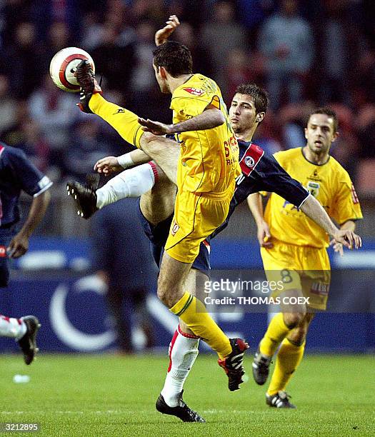 Paris Saint-Germain's Albanian midfielder Lorik Cana and Nantes's defender Sylvain Armand try to intercept the ball during their French L1 football...