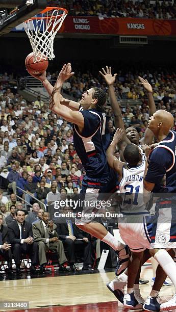 Josh Boone of the UConn Huskies drives to the basket against the Duke Blue Devils defense during the semifinal game of the NCAA Final Four Tournament...