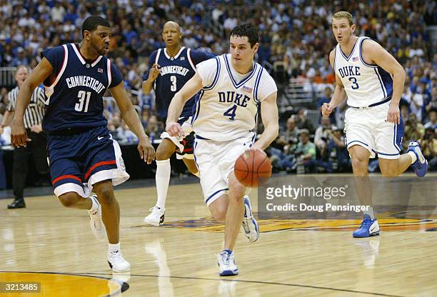 Redick of the Duke Blue Devils is guarded by Rashad Anderson of the UConn Huskies during the semifinal game of the NCAA Final Four Tournament on...