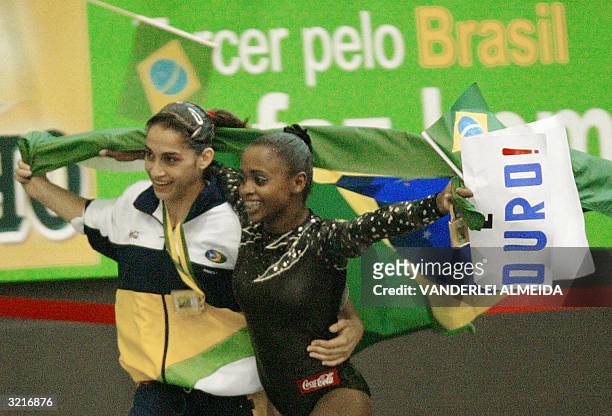 Brazilian gymnasts Daniele Hypolito and Daiane dos Santos celebrate their Gold medals won during the 3rd stage of the World Cup of gymnastics, 04...