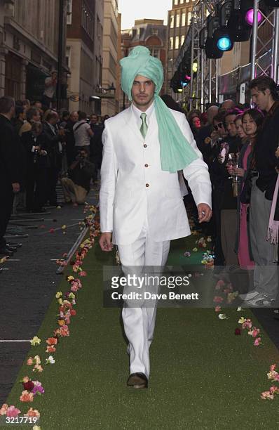 Model walks the outdoors catwalk during the street party and collection preview in Saville Row on 12th February 2002 to mark the new couture...