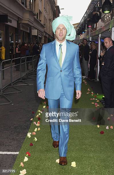 Model walks the outdoors catwalk during the street party and collection preview in Saville Row on 12th February 2002 to mark the new couture...