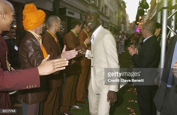 Designer Ozwald Boateng walks his catwalk after the show during the street party and collection preview in Saville Row on 12th February 2002 to mark...
