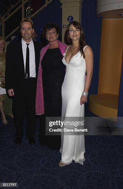 Actress and model Elizabeth Hurley with Rosa Monkton and John Furnish at the Grosvenor House Antiques Fair Charity Gala. The patron was Elizabeth...