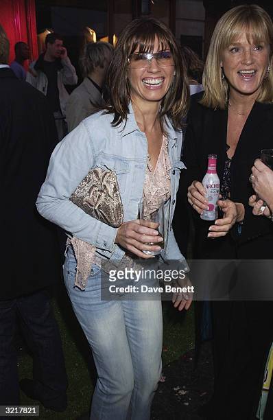 Stacey Young, wife of singer Paul Young, and her freind Elaine during the street party and collection preview in Saville Row on 12th February 2002 to...