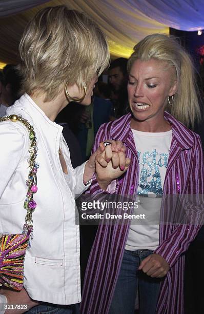 Socialite Tamara Beckwith shows off her ring to Nichola Fomby during the street party and collection preview in Saville Row on 12th February 2002 to...