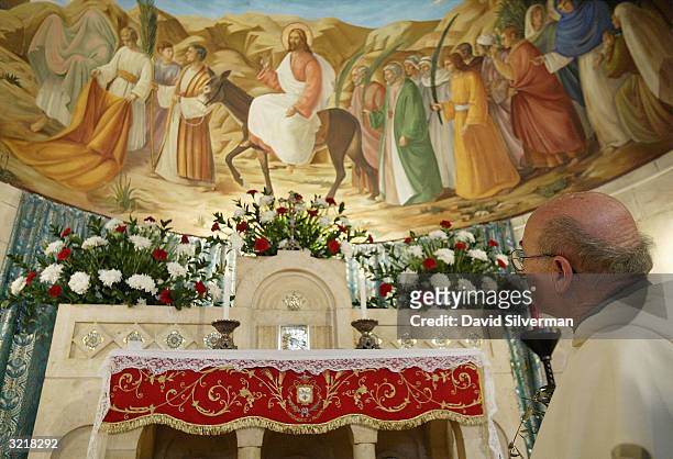 Catholic priest prays in the chapel of Beth Page, on the Mt. Of Olives, the starting place of the annual Palm Sunday procession into the holy city on...