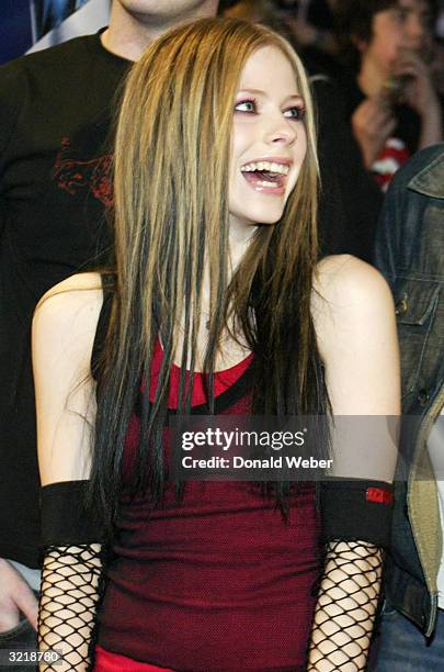 Musician Avril Lavigne smiles as she and members of her band arrive for the JUNO Awards ceremony at the Rexall Centre April 4, 2004 in Edmonton,...