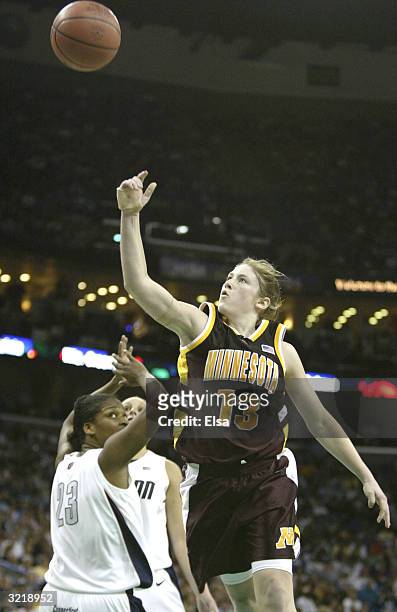 Lindsay Whalen of the Minnesota Golden Gophers shoots over Willnett Crockett of the University of Connecticut Huskies during the semifinal game of...