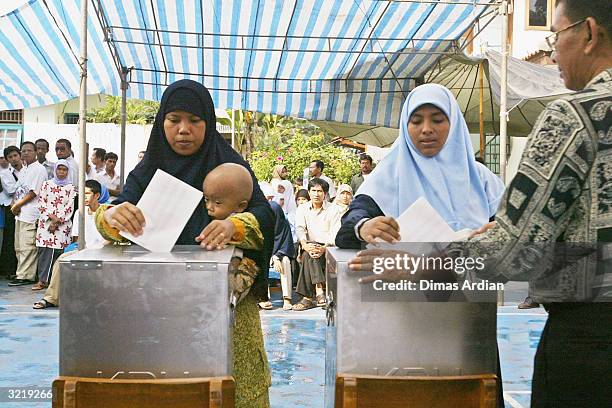 Indonesian Muslim women queue to cast their vote, on April 5, 2004 in Jakarta, Indonesia. Around 147 million eligible voters in the world's most...