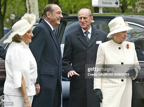 Queen Elizabeth II and her husband Prince Philip are greeted by French President Jacques Chirac and first lady Bernadette on the Champs Elysees...