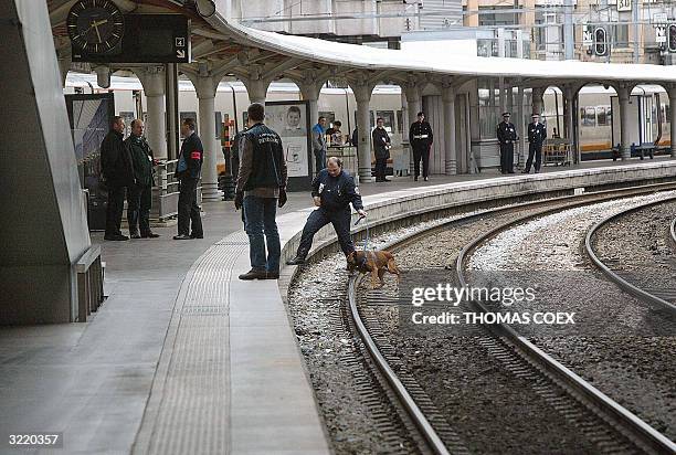 French police secure the tracks at Gare du Nord train station before the arrival of Queen Elizabeth II and her husband Prince Philip 05 April 2004,...