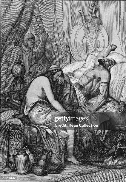 Several men peer through a curtain at the body of Attila , king of the Huns, which lies on a bed while his wife of one night, Ildico, weeps at his...