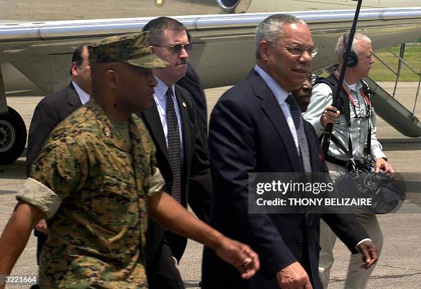 Secretary State Collin Powel arrives at the Haitian International Airport 05 April 2004 in Port-au-Prince. Powell, in Haiti to show support for the...