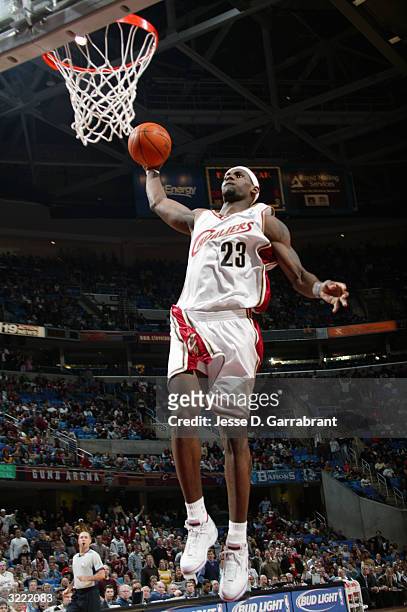 LeBron James of the Cleveland Cavaliers goes up for a slam dunk during the game against the Utah Jazz at Gund Arena on March 19, 2004 in Cleveland,...