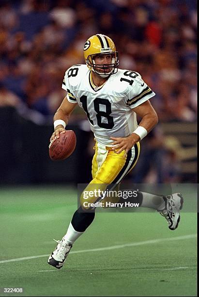 Doug Pederson of the Green Bay Packers runs out of the pocket, looking for an open receiver down field during the NFL American Bowl Game against the...