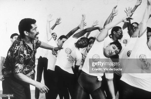 American dancer and choreographer Alvin Ailey instructs students during a class for the blind and visually impaired, New York City. Ailey founded the...