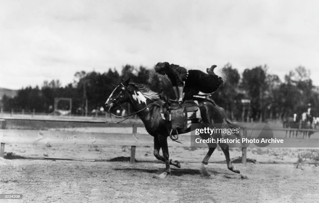 Fancy Trick Riding Full-length image of rider Tillie Baldwin swinging her legs over the ...
