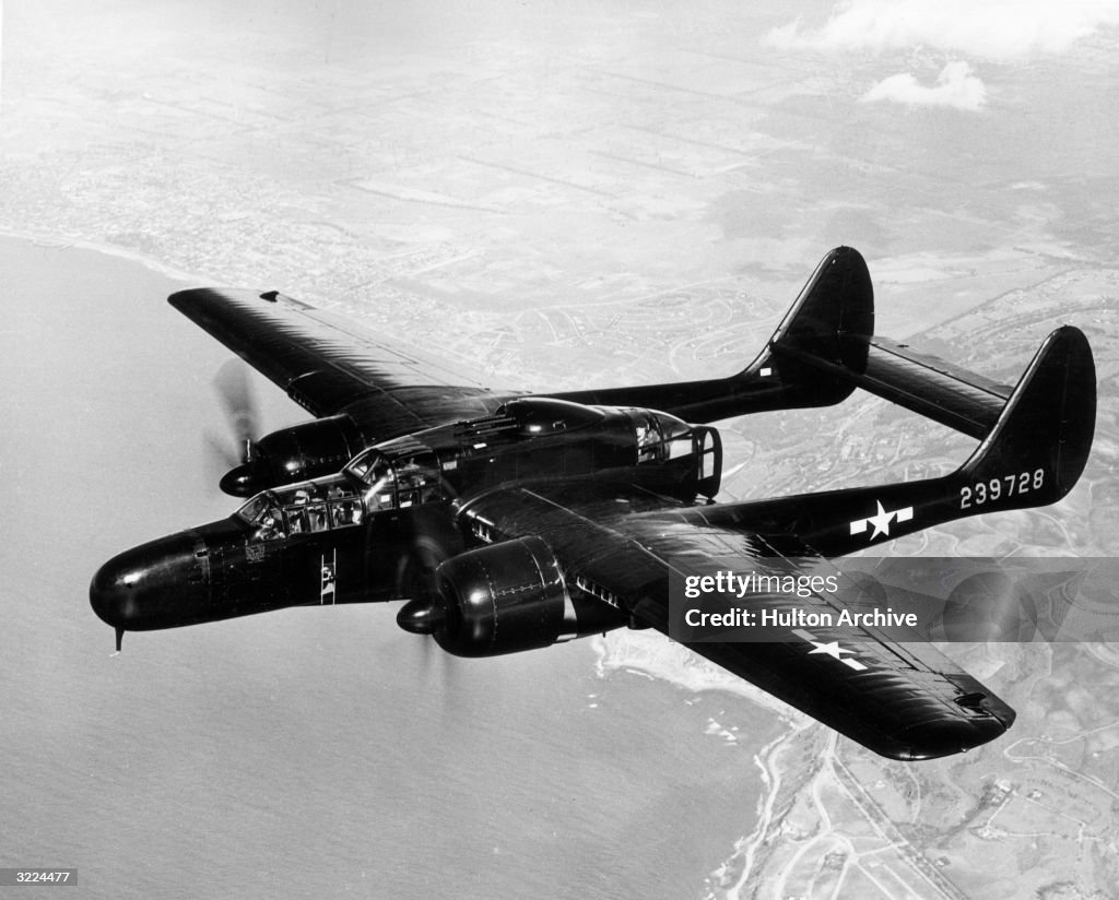 F61 Jet A Northrop Black Widow P-61 flies over a coastline during daylight ...