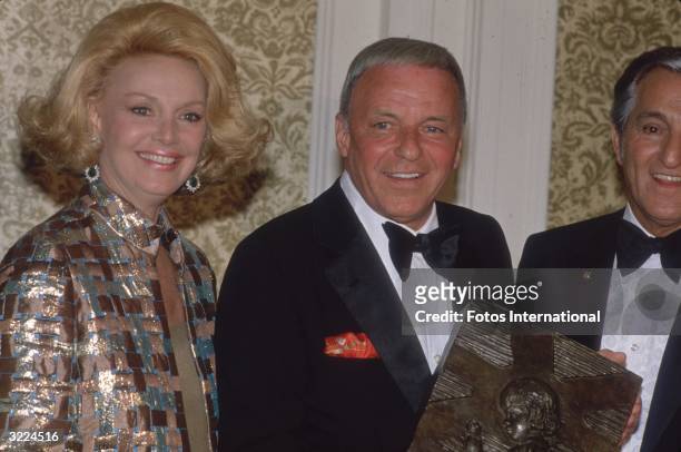 American singer and actor Frank Sinatra with his fourth wife, actor Barbara Marx, and American comedian Danny Thomas, at the St Jude's Children's...