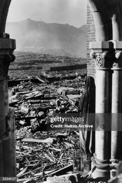 Statue standing in an archway at Urakami Catholic Cathedral looks out across the devastation towards Chinzei Mission School in the distance, after...