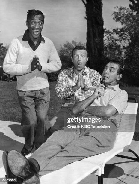 American actors and comedians Sammy Davis Jr. , Dave Barry and Eddie Cantor clowning outdoors. Davis, who was appearing at Ciro's at the time, was...