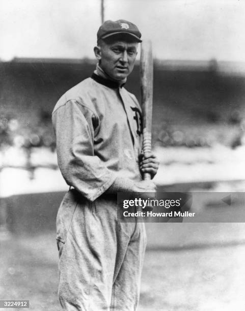 Detroit Tiger Ty Cobb posing in his uniform and holding a bat.