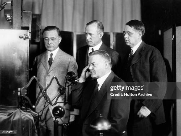 American politician Herbert Hoover , then Secretary of Commerce, taking part in the first public demonstration of intercity television broadcasting...