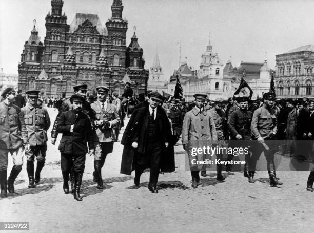 Communist leader Vladimir Ilyich Lenin walking through Red Square with a group of military commanders, Moscow, U.S.S.R. .