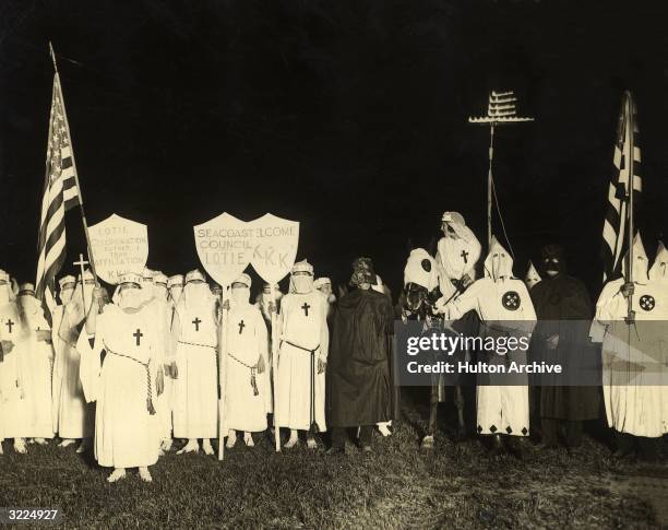 The Royal Riders of the Red Robe and the Ladies of the Invisible Empire, branch groups of the Ku Klux Klan , at a night gathering with the social...