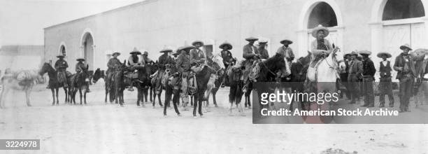 Panoramic view of Mexican revolutionary Pancho Villa and his followers on horseback, Mexico.